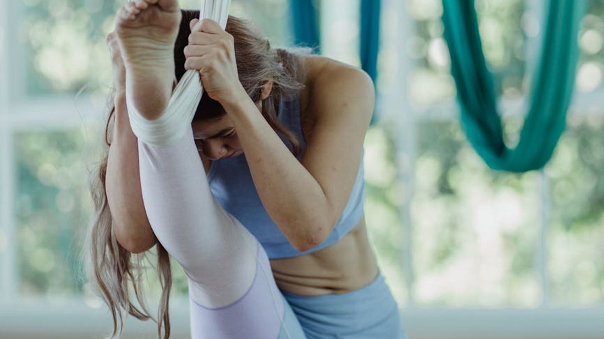 Woman practicing mindful movements in a bright airy room